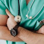 Crop doctor with stethoscope in hospital